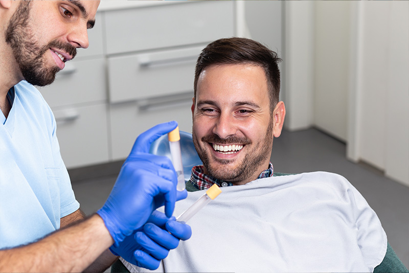 dentist showing patient tubes of platelet rich fibrin