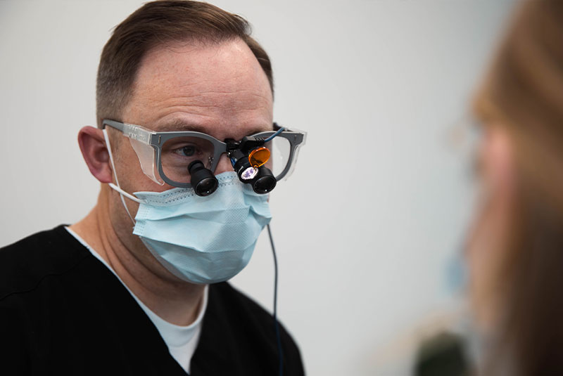 doctor during dental procedure within the operating room at the dental practice